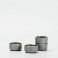 A set of four aqua grey ceramic ramekins with a matte-finished, lightly speckled surface, displayed against a white background.